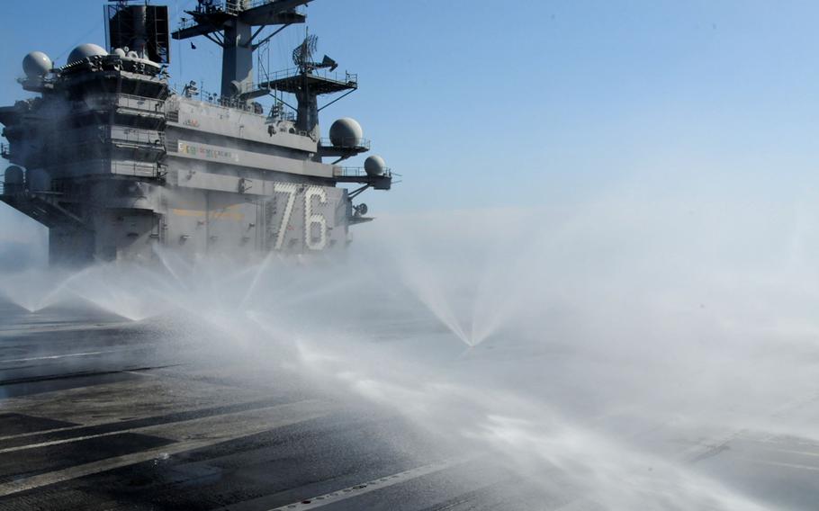 Sprinklers wash down the flight deck of the USS Ronald Reagan, March 23, 2011, during the aircraft carrier’s humanitarian mission Operation Tomodachi, off the northeast coast of Japan.