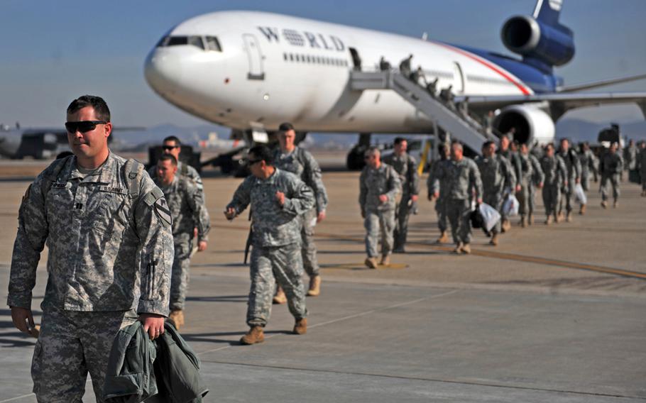 Members of the 1st Battalion, 12th Cavalry Regiment arrive at Osan Air Base, Republic of Korea, Jan. 29, 2014. The approximately 800 troops are from Fort Hood, Texas. 