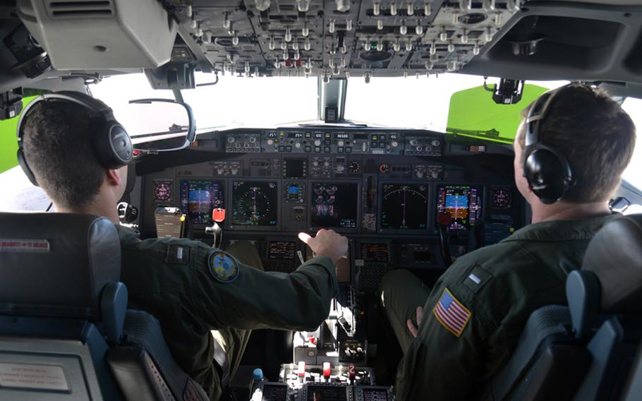 Lt. j.g. Kyle Atakturk, left, and Lt. j.g. Nicholas Horton, naval aviators assigned to Patrol Squadron (VP) 16, pilot a P-8A Poseidon during a mission to assist in search and rescue operations for Malaysia Airlines flight MH370. VP-16 is deployed in the U.S. 7th Fleet area of responsibility supporting security and stability in the Indo-Asia-Pacific region. 