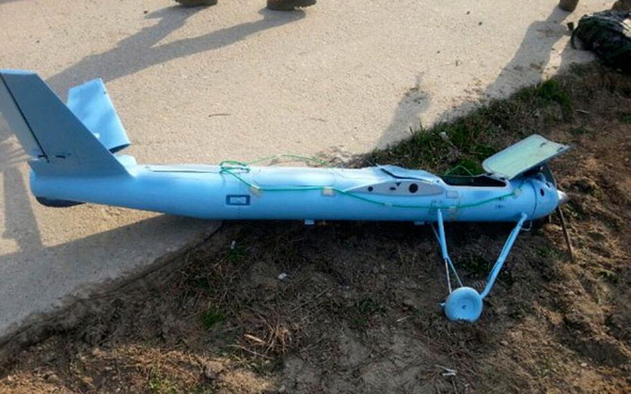 A damaged drone is seen on the ground on Baengnyeong Island, South Korea, in this photo released by the South Korea Defense Ministry on Wednesday, April 2, 2014.