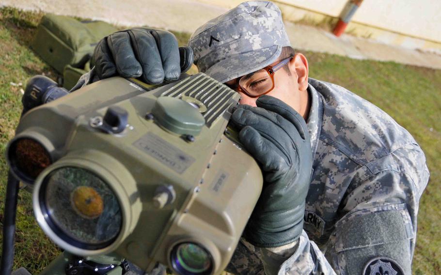 A soldier looks through a Lightweight Laser Designator Rangefinder (LLDR) during training in Hohenfels, Germany, March 6, 2013. 