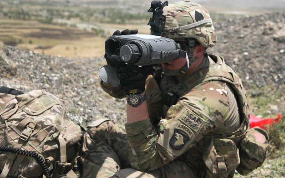 A soldier with the 101st Airborne Division looks through a Lightweight Laser Designator Rangefinder (LLDR) in the Khowst province of Afghanistan, June 2, 2013.