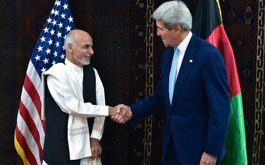 U.S. Secretary of State John Kerry shakes hands with Afghan presidential candidate Ashraf Ghani at the U.S. Embassy in Kabul on Friday, July 11, 2014.