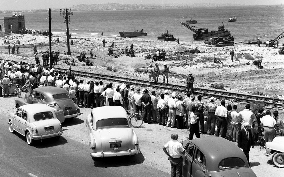 Local residents — and enterprising taxi drivers — watch as American forces land in Lebanon in July, 1958.