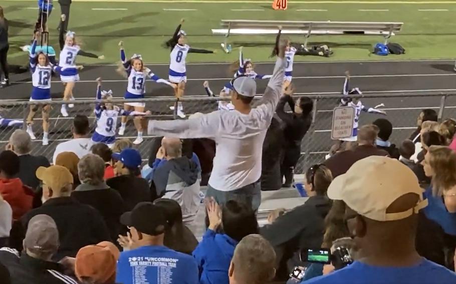 Retired Air Force Major Rolland “Hekili” Holland, known as “Cheer Dad,” performs in sync with the cheerleaders from his daughter’s high school in Yorktown, Va. in this screenshot taken from an Oct. 1, 2020 video posted to social media.