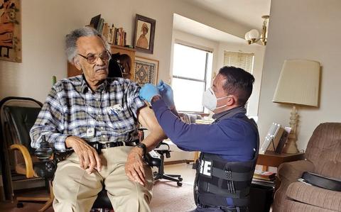 Tuskegee Airman James Clayton Flowers receives the second dose of the COVID-19 vaccine in his home Tuesday, Feb. 16, 2021.