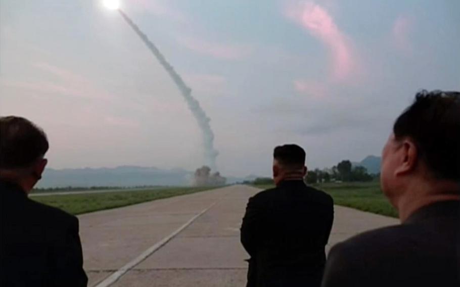 North Korean leader Kim Jong Un and other officials watch a ballistic missile launch in this undated photo from the state-run Korean Central News Agency.