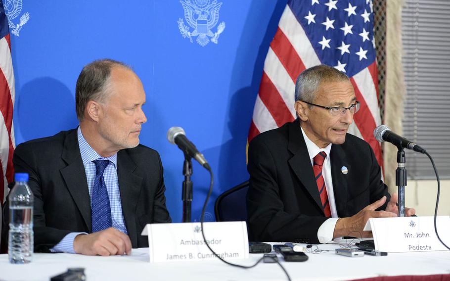 John Podesta, a senior adviser to President Barack Obama, speaks to reporters at the U.S. Embassy in Kabul on Sept. 29, 2014, as U.S. Ambdassador James Cunningham, left, listens. The two had earlier attended the inauguration of the new Afghan president, Ashraf Ghani. Podesta said the Obama administration is looking forward to a new chapter in Afghan-American relations.


