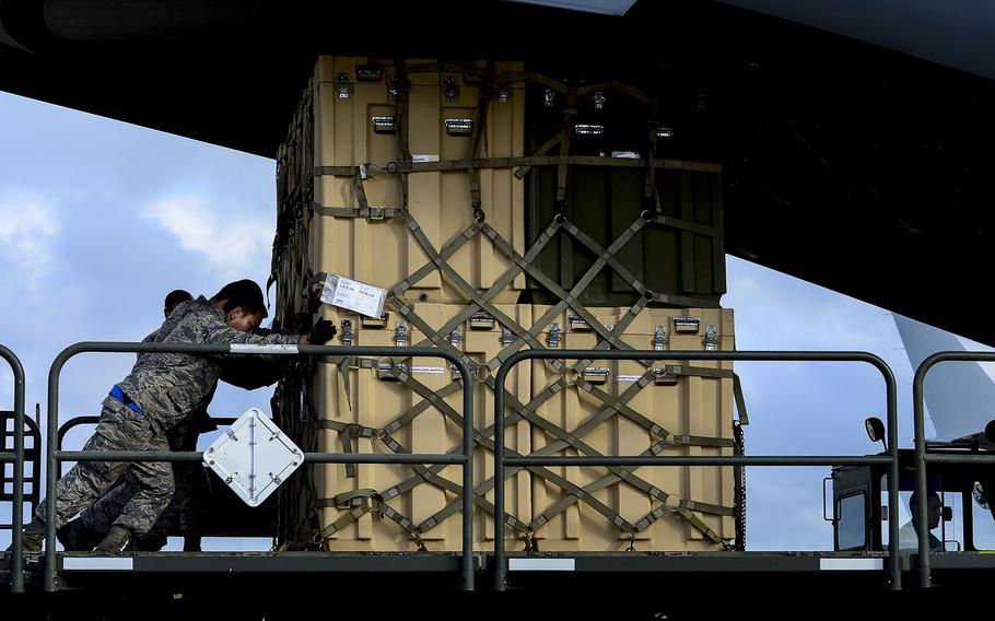 Airmen load cargo onto a C-17 Globemaster at Langley Air Force Base, Va., on Sept. 26, 2014. The C-17 was used to ship the Air Force's Expeditionary Medical Support System, sent as part of a U.S. government effort to support humanitarian relief operations in Ebola-stricken African nations.
