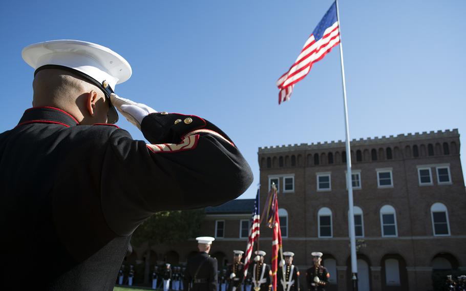 A US Marine salutes the American flag at the Marine Barracks in Washington, D.C., at the start of the Passage of Command ceremony on Oct. 17, 2014. 