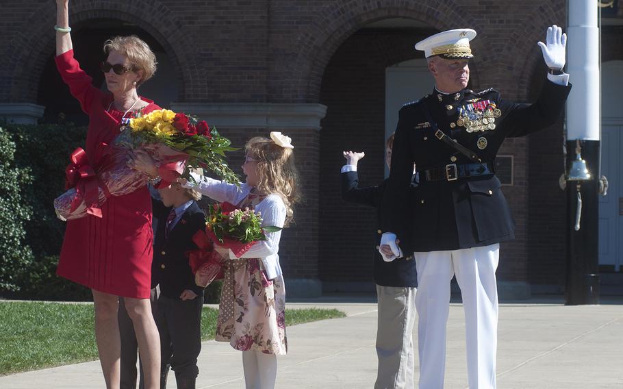 General Amos and his wife waves goodbye to the audience at the conclusion of the Passage of Command at the Marine Barracks in Washington, D.C., on Oct. 17, 2014.