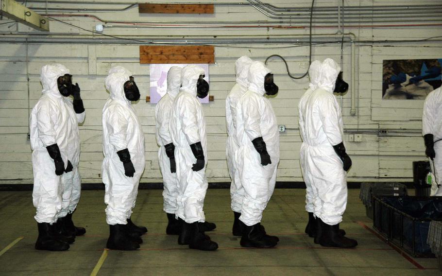 Troops at Fort Campbell, Ky., wear personal protective equipment Monday, Nov. 17, 2014, during training for the military's Ebola response mission in West Africa.