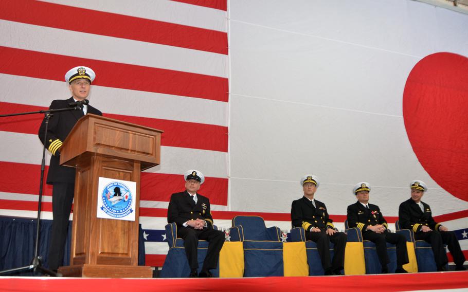 Capt. Timothy Kuehhas addresses the gallery in the USS George Washington's hangar deck, just prior to assuming command of the ship on Jan. 30, 2015. Kuehhas is tasked with preparing the ship for a multibillion-dollar refueling and overhaul after it returns to the United States later this year. 