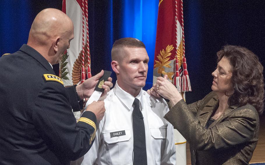 Sgt. Maj. Daniel Dailey has his new rank insignia put on his shirt after becoming the 15th Sergeant Major of the Army during a swearing-in ceremony at the Pentagon in Arlington, Va., on Jan. 30, 2015. Helping to put on his new rank is Dailey's wife, Holly, and Gen. Ray Odierno, chief of staff of the Army. 