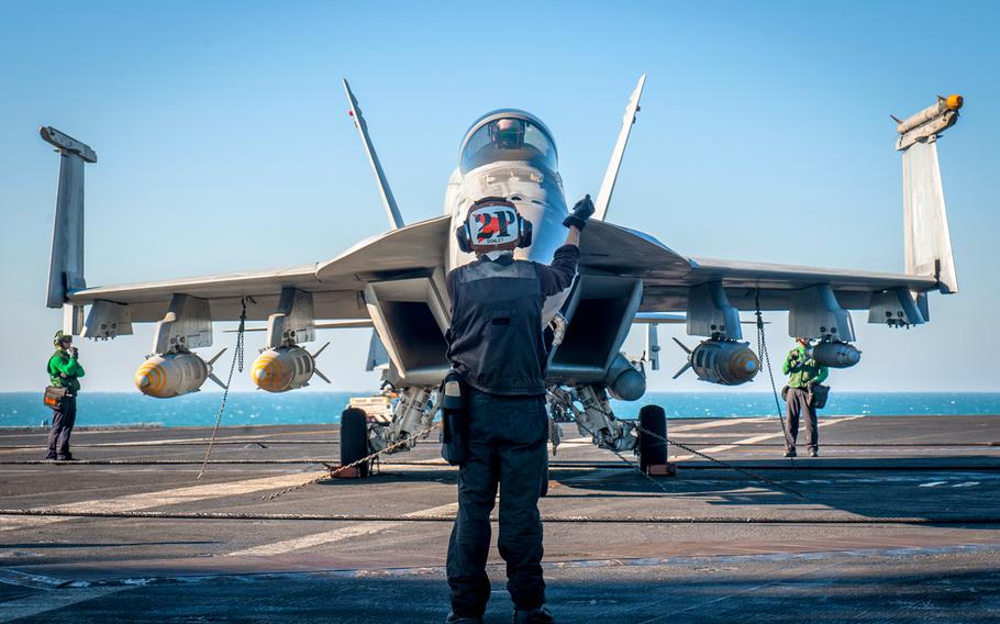 Airman Dylan Donley conducts engine startups Jan. 14, 2015, for an F/A-18E Super Hornet on the flight deck of the aircraft carrier USS Carl Vinson in support of strike operations in Iraq and Syria.