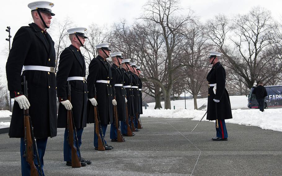 Marines stand poised to preform drill movements during the Iwo Jima Wreath Laying Ceremony at the Marine Corps War Memorial in Arlington, Va. on Feb. 19, 2015. The wreath laying recognized the 70th anniversary of the battle and the veterans' sacrifice.