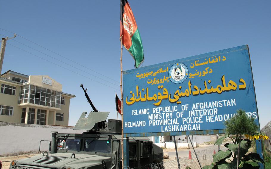 A Humvee sits parked next to the Helmand provincial police headquarters sign in Lashkar Gah, Afghanistan, in this file photo from July 2, 2012. A suicide car bombing on Monday killed 14 people, including 10 Afghan police officers, as the Taliban launched a large-scale attack on the capital in southern Helmand province, the heartland of the insurgency.