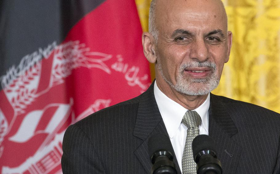 President Ashraf Ghani of Afghanistan stands in front of his nation's flag during a press conference at the White House, Mar. 24, 2015.