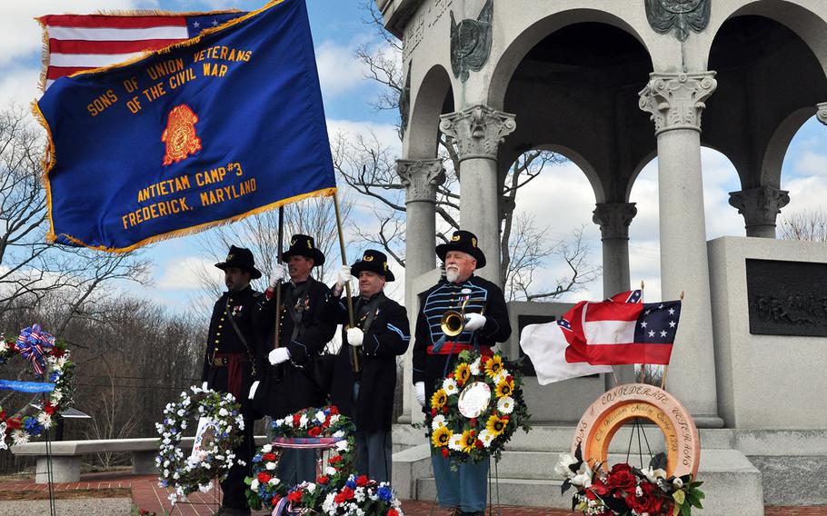 An honor guard of the Gettysburg Blues, Sons of Union Veterans of the Civil War, stand before a memorial to Maryland soldiers at the Battle of Antietam. The 20 Union soldiers who were awarded the Medal of Honor wqere remembered at ceremonies at the battlefield on Saturday.