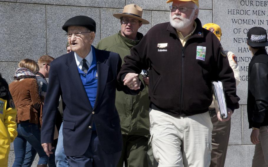 Coast Guard veteran Carroll H. George (left)  arrives for his very first visit to the World War II Memorial  on April 1, 2015. George, 95, fought in the Battle of Okinawa and participated in a wreath-laying to commemorate the 70th anniversary of the battle.