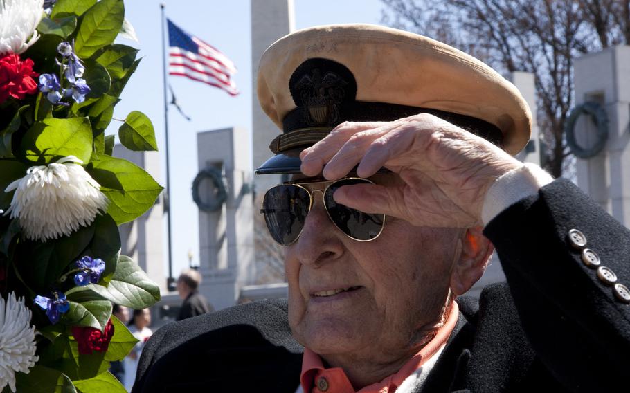 Navy veteran John Cassidy, who fought in the Battle of Okinawa, adjusts his cap at the World War II Memorial on April 1, 2015. Cassidy participated in a wreath-laying as part of a ceremony commemorating the 70th anniversary of the battle. 
