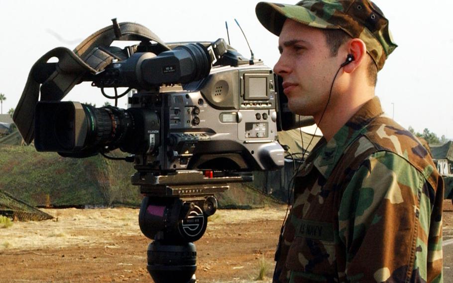 Navy Petty Officer 2nd Class Andrew Krauss with the then-Pentagon Channel films an interview at the Montgomery Airfield in San Diego, Calif., in October, 2007.