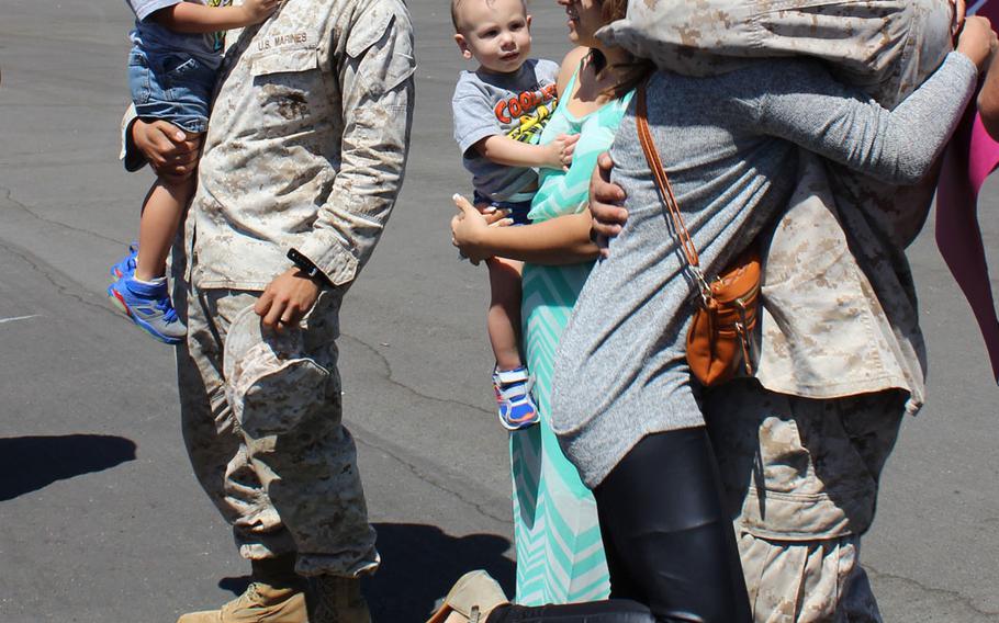 Marines embrace their loved ones at Camp Pendleton, Calif., on Tuesday, April 14, 2015, after returning from a 7 1/2-month deployment to the Middle East with Special Purpose Marine Air Ground Task Force-Crisis Response-Central Command.