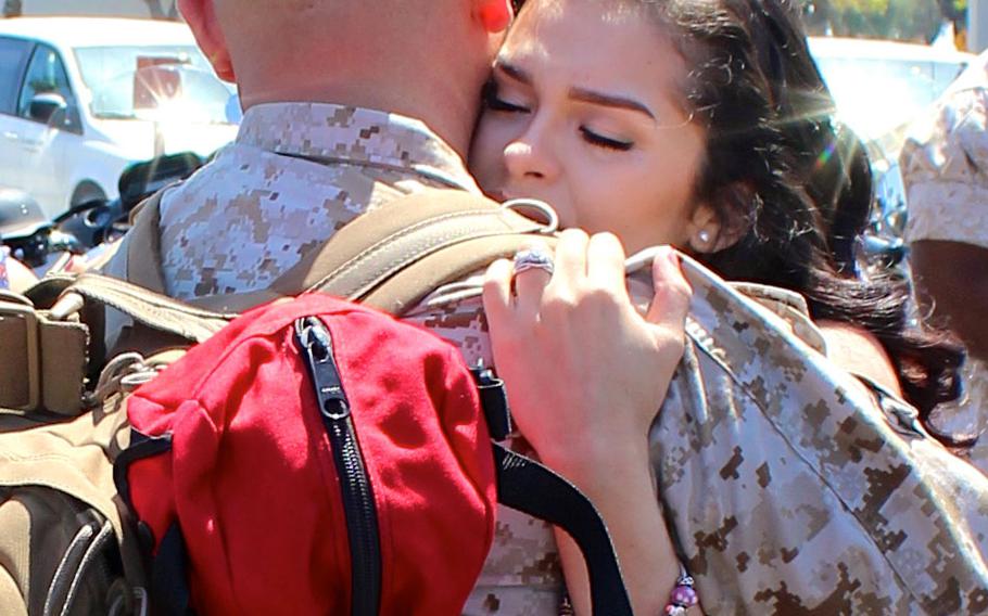 Staff Sgt. Jose Jimenez hugs his wife, Adela, after returning home to Camp Pendleton, Calif., on Tuesday, April 14, 2015, from a 7 1/2-month deployment to the Middle East. Jimenez, his wife and infant daughter moved to California 2 months before the Marine left for deployment.