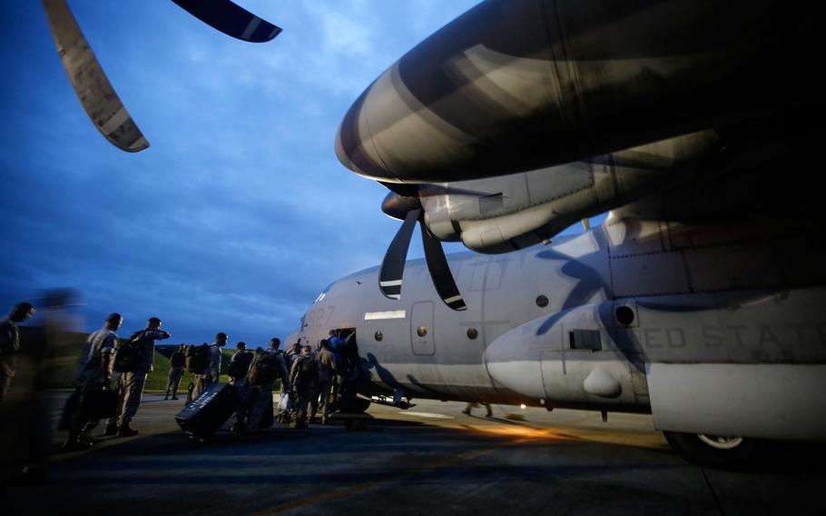 U.S. Marines and U.S. Agency for International Development members board a U.S. KC-130 at K-5 Right, Kadena Air Base, Okinawa, Japan, April 29, 2015. The team is traveling to Nepal to determine what assets will be required to aid the country devastated by an earthquake April 25.