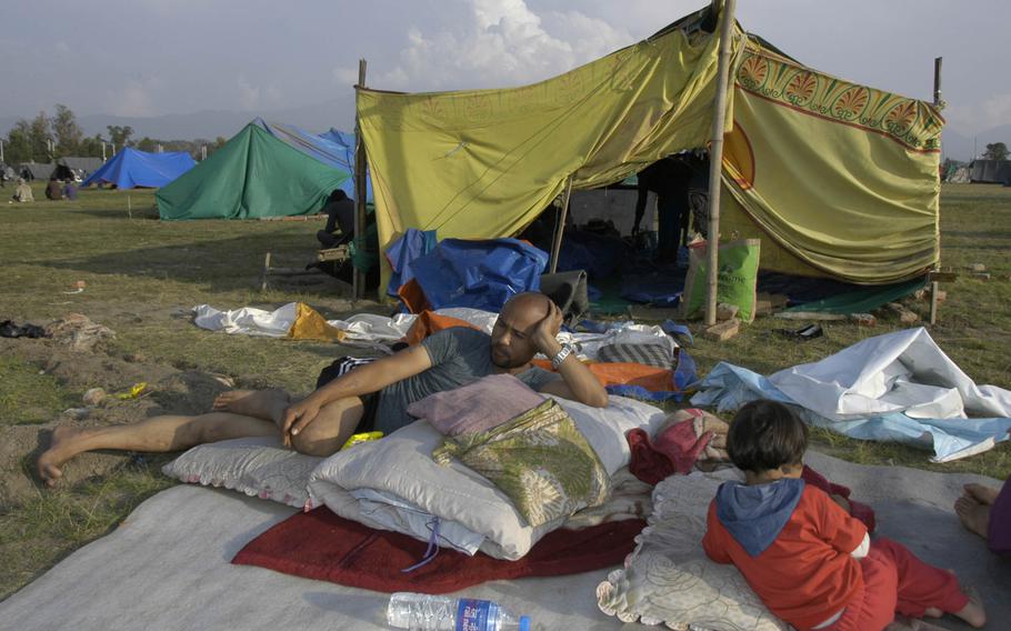 Nepalese earthquake survivors camp out on a sports fields in the capital, Kathmandu on Saturday, May 2, 2015. 

