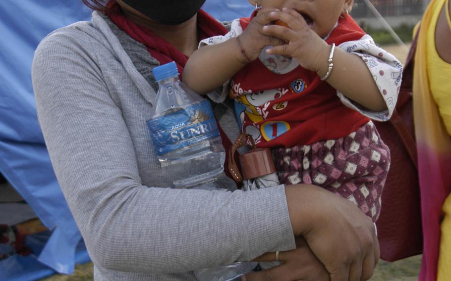 A mother and child sheltering at a camp for earthquake survivors in Nepal's capital, Kathmandu, on Saturday, May 2, 2015. 