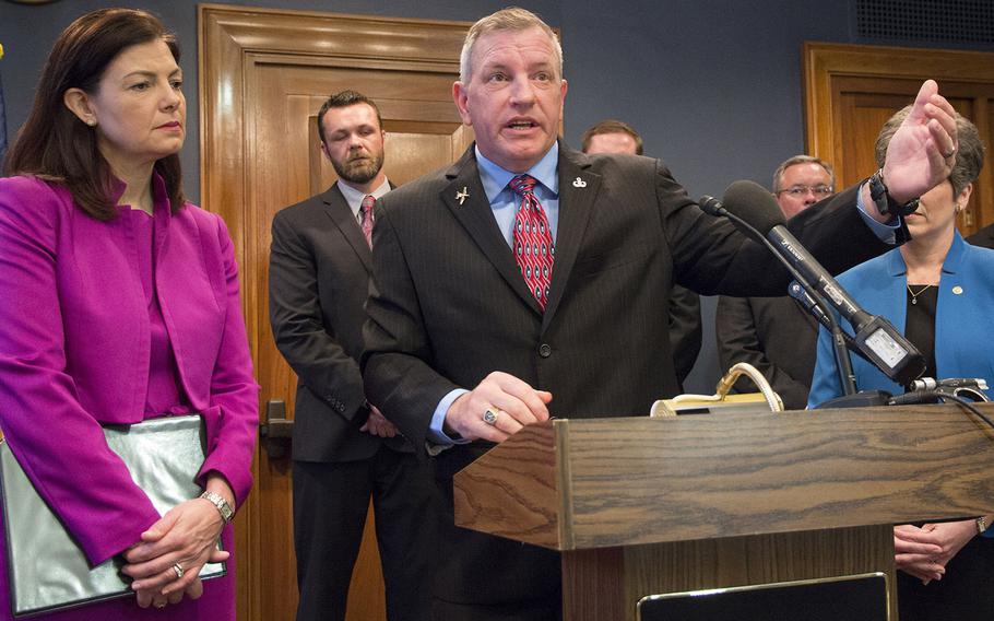 Retired Master Sgt. Tim Stamey makes a point in defense of the A-10 Warthog aircraft during a Capitol Hill press conference, May 5, 2015. At left is Sen. Kelly Ayotte, R-N.H., left, and in the background at left is Charlie Keebaugh, president of the Tactical Air Control Party Association.