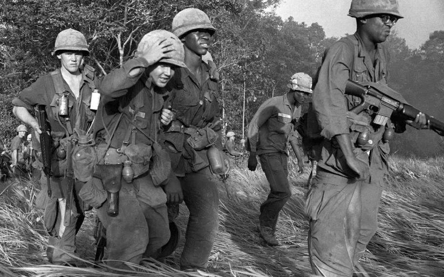 Wounded soldiers are evacuated from an area near Dau Tieng, Vietnam, in November, 1966.