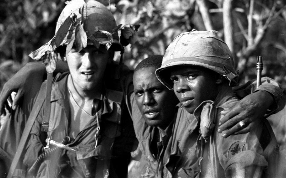 A wounded soldier is helped to a waiting helicopter by two of his comrades during Operation Attleboro near Near Tay Ninh, WSouth Vietnam, in November, 1966.