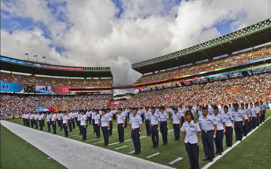 Several hundred airmen assigned to Pacific Air Forces Hawaii stand at attention on the field at Aloha Stadium on Jan. 29, 2012, during the National Football League Pro Bowl halftime show in Honolulu, Hawaii, where the NFL paid tribute to the men and women in uniform.