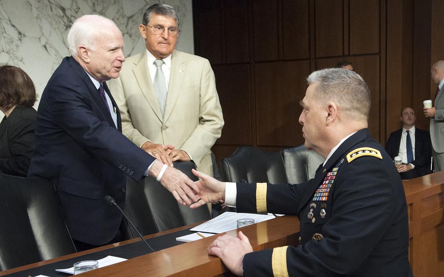 Gen. Mark Milley shakes hands with Senate Armed Services Committee Chairman Sen John MaCain, R-Ariz., on Tuesday, July 21, 2015, prior to a hearing on Capitol Hill in Washington D.C., where committee members considered Milley's nomination to be the next Army chief of staff. Sen. Joe Manchin III, D-W.Va., looks on.