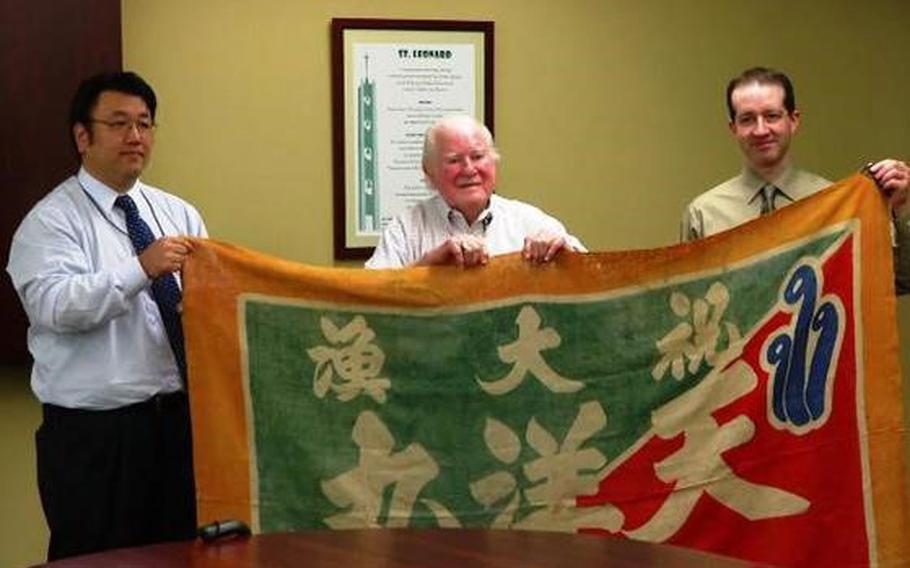 A flag recovered from a sunken Japanese warship was returned to its home port by Pete Losh, 94, of Dayton, Ohio.