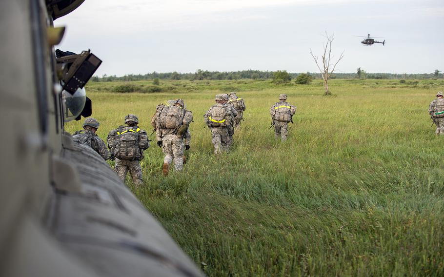 Soldiers start a 12-mile ruck march through the Fort Drum training area on July 17, 2015. The Army announced Wednesday, Aug. 5, 2015, that roughly 3,000 soldiers, many from Fort Drum, N.Y., will deploy to Iraq and Afghanistan in the coming months.