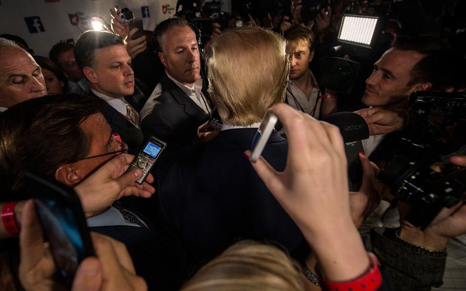 Donald Trump speaks with the media in the spin room after the Republican presidential debate at the Quicken Loans Arena on Thursday, Aug. 6, 2015, in Cleveland, Ohio.