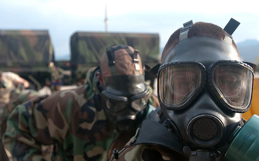 Members of the Chemical, Biological, Radiological, Nuclear, Explosives Command don gas masks in a training event on Nov. 9, 2011. The CBRNE Command typically participates in the Ulchi Freedom Guardian exercises in South Korea.