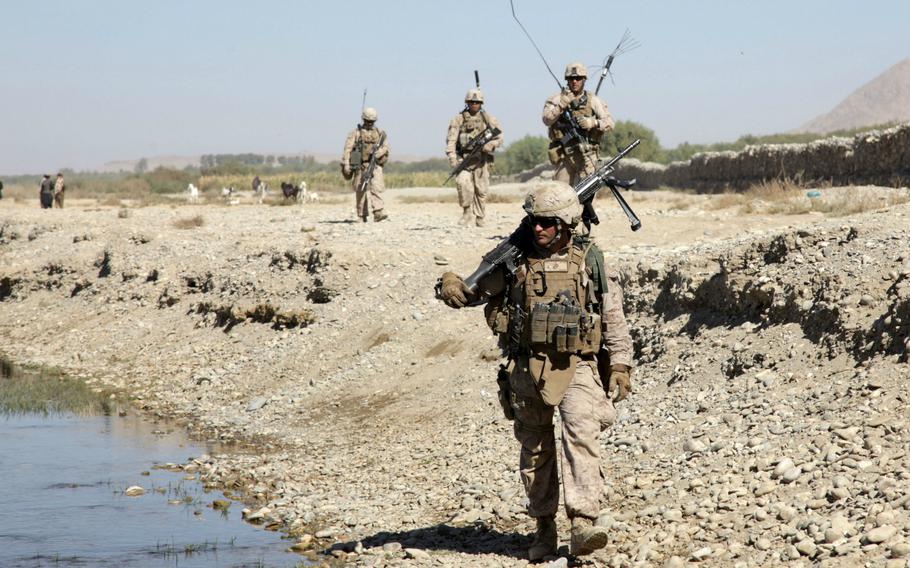 In this file photo from Oct. 19, 2013, U.S. Marines patrol near Forward Operating Base Musa Qala, Helmand province, Afghanistan.