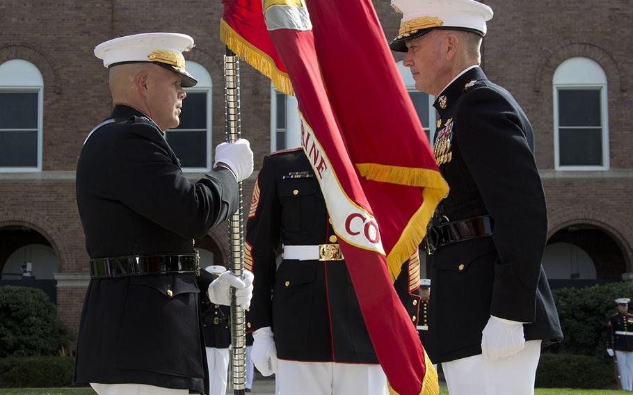 Commandant of the Marine Corps, Gen. Robert B. Neller, left, accepts the Marine Corps colors from Gen. Joseph F. Dunford, Jr., right, at Marine Barracks Washington, D.C., Sept. 24, 2015. Neller took command from Dunford as the 37th Commandant of the Marine Corps.