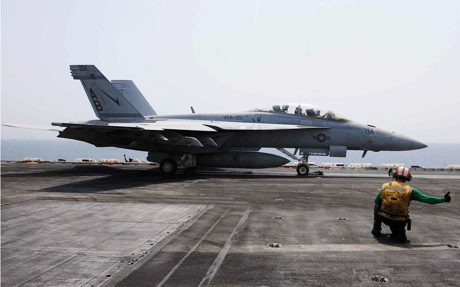 A safety observer gives the approval for an F/A-18F Super Hornet to launch on the flight deck aboard the aircraft carrier USS Theodore Roosevelt on Sept. 7, 2015. Theodore Roosevelt is deployed in the U.S. 5th Fleet area of conducing strike operations in Iraq and Syria.