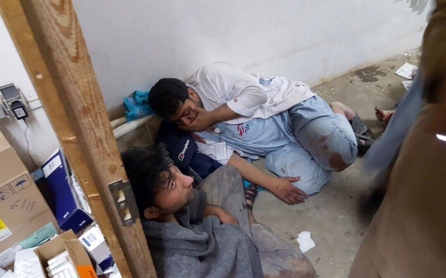 Medical staff take shelter after their hospital, run by Doctors Without Borders, was struck by bombs during fighting in Kunduz, Afghanistan, early on Saturday, Oct. 3, 2015. The U.S. military reported that an American airstrike may have struck a hospital.