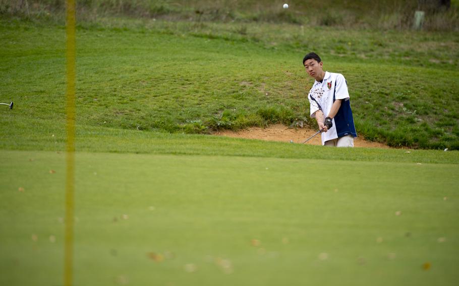 Ramstein's Daniel Shin chips a shot out of the sand bunker during the DODDS-Europe golf championship at Rheinblick golf course in Wiesbaden, Germany on Wednesday, Oct. 7, 2015. Shin was down 12 points after day one, was able to reduce the leader's advantage down to five, but ultimately finished in second place.