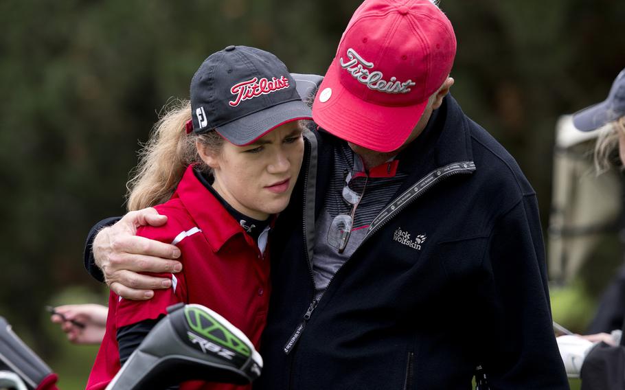 Kaiserslautern's Jasmin Acker is comforted by her father, Daniel Acker, during the DODDS-Europe golf championship at Rheinblick golf course in Wiesbaden, Germany on Thursday, Oct. 8, 2015. Acker had a rough start during the first nine holes, but was able to pull ahead and win the girls' division.