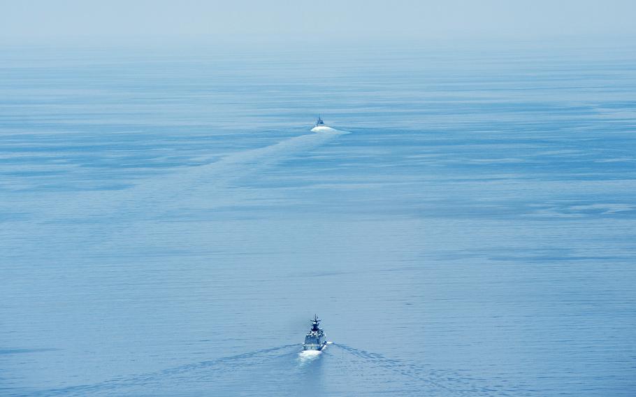 The littoral combat ship USS Fort Worth conducts routine patrols in international waters of the South China Sea near the Spratly Islands as the People's Liberation Army-Navy guided-missile frigate Yancheng sails close behind on May 11, 2015.