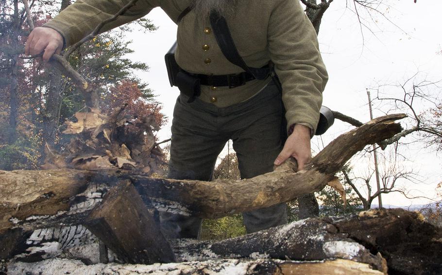 A Confederate reenactor tends to his campfier at Gettysburg National Military Park, Oct. 31, 2015.