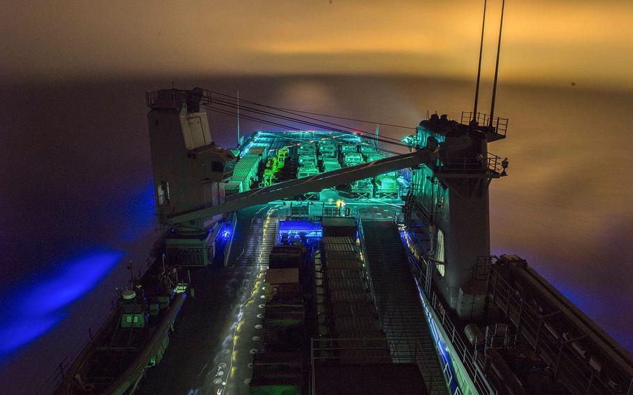 Dock landing ship USS Harpers Ferry prepares for night time flight operations Dec. 7, 2015. 