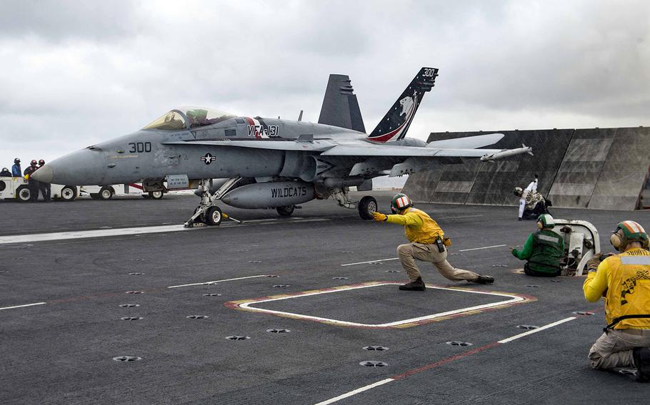 An F/A-18C Hornet assigned to the Wildcats of Strike Fighter Squadron 131 prepares to launch from the flight deck of the aircraft carrier USS Dwight D. Eisenhower Dec. 7, 2015. 